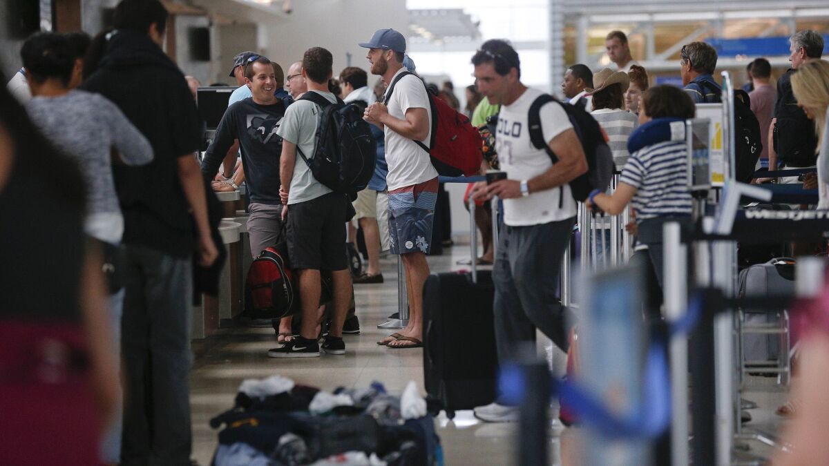 Travelers wait in lines at the Fort Lauderdale Hollywood International Airport on June 29. The Transportation Security Administration said that Friday was the second busiest day in the history of the agency.