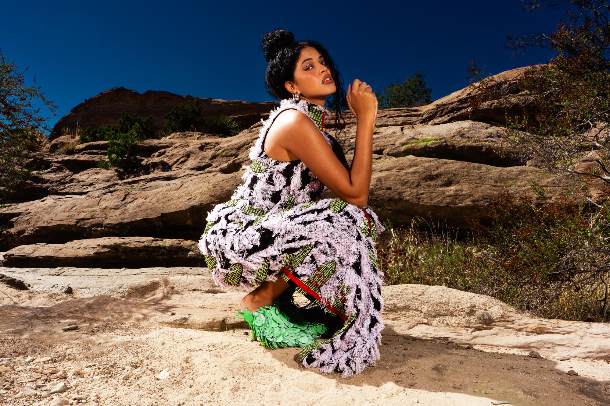 The artist Yendry poses in the desert.