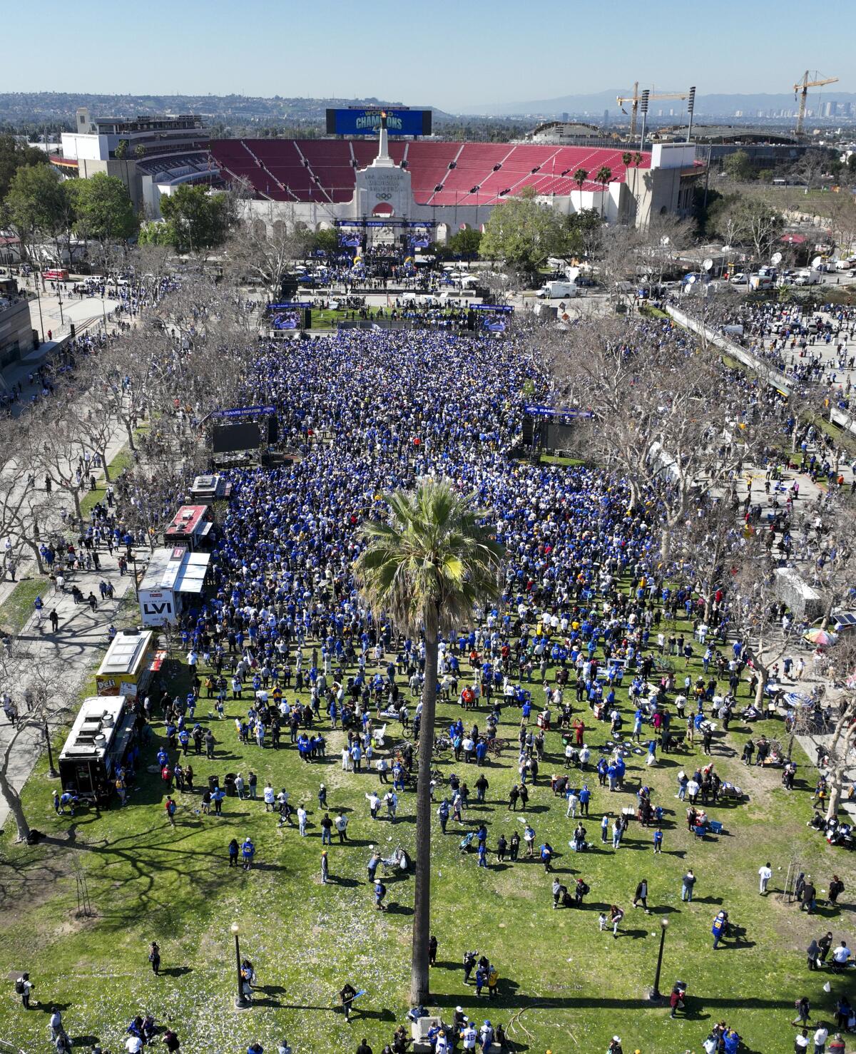 Aerial view of crowds celebrating the Rams' Super Bowl LVI championship parade and rally on Exposition Park at the Coliseum.