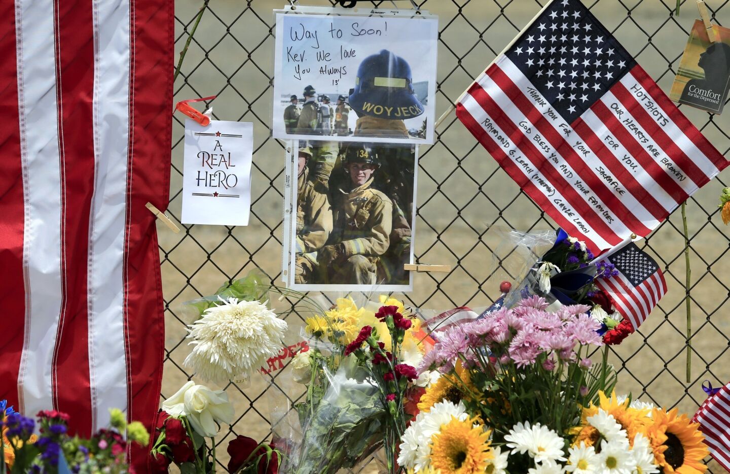 Firefighter Kevin Wyjeck is remembered with pictures on the fence surrounding Fire Station 7 in Prescott.