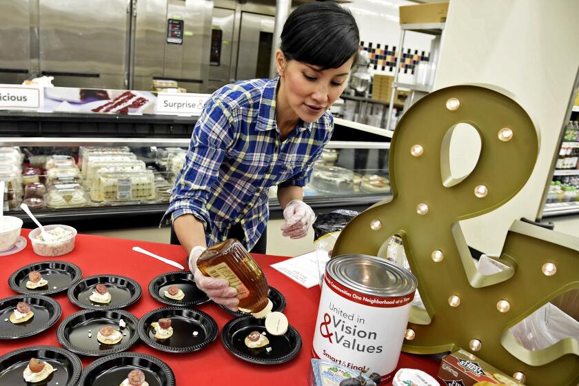 Naomi Robinson of Baker's Royale prepares hors d'oeuvre during a cooking demonstration at Smart & Final Extra! as part of an event celebrating the 145th anniversary of Smart & Final on Thursday, Nov. 10, 2016, in Burbank, Calif.