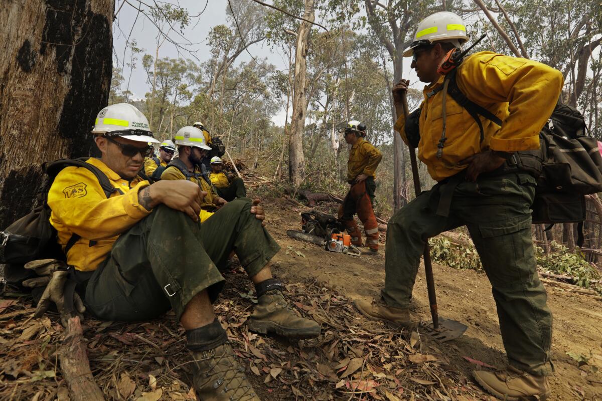 American fire fighters, 20 National Angeles Forest firefighters, take a break after working to put out hot spots in the Alpine National Park.