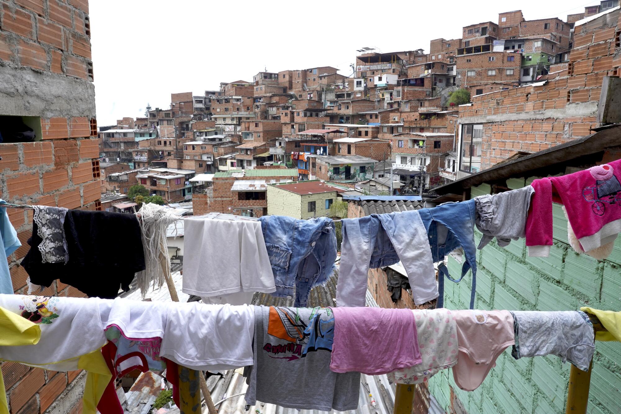 Clothes hangs outside with the city in the background.