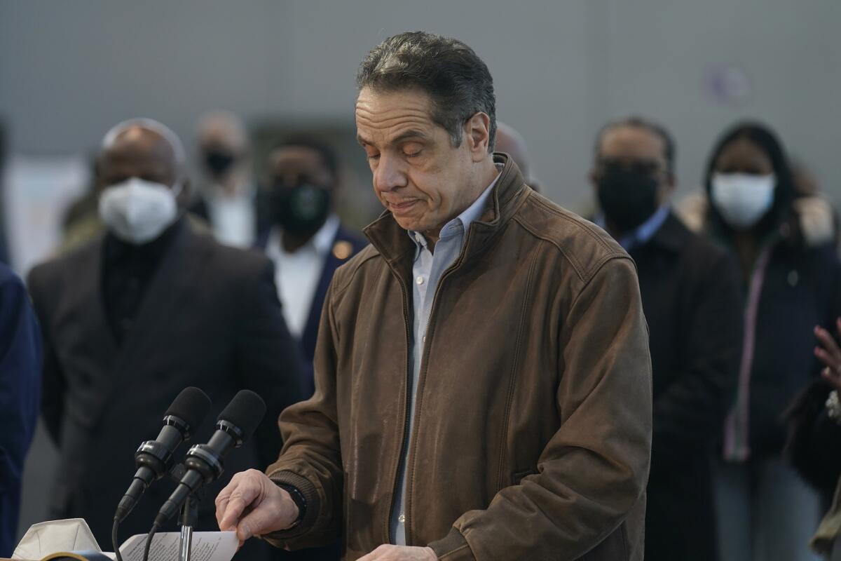 Gov. Andrew Cuomo speaks in front of two microphones