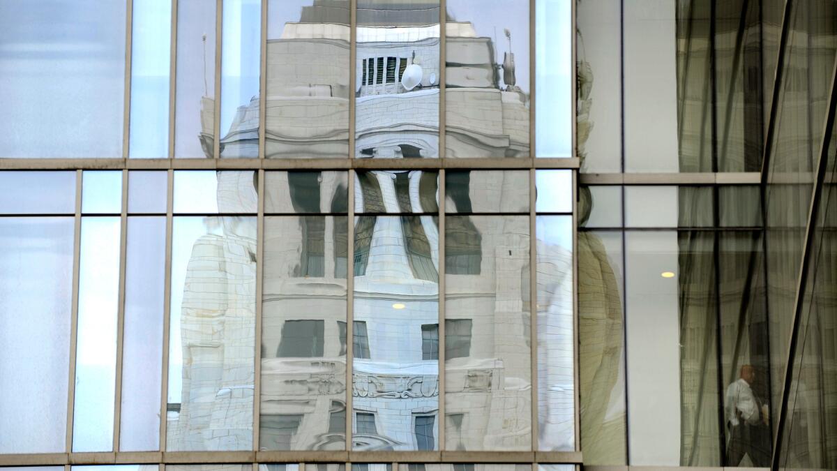 City Hall is reflected in the windows of LAPD headquarters in downtown Los Angeles.