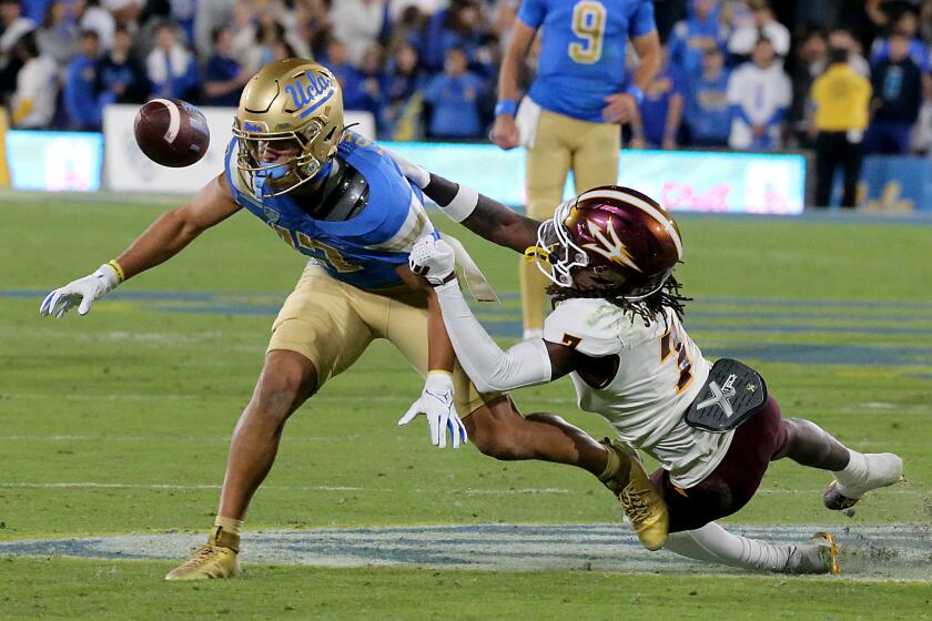 Pasadena, CA - UCLA wide receiver Logan Loya can't hang on to a pass from quarterback Colin Schlee.