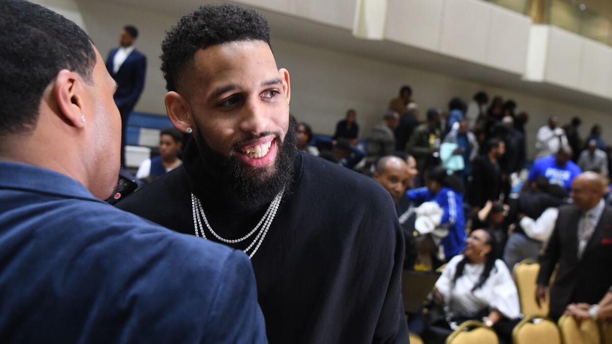 Allen Crabbe is greeted during a court-naming ceremony at Price Christian Schools, which is part of the Crenshaw Christian Center in Los Angeles.