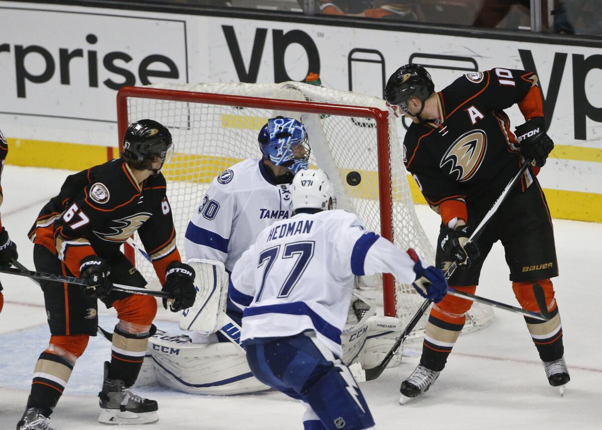 Ducks right wing Corey Perry, right, and center Rickard Rakell (67) watch with Lightning goalie Ben Bishop as the puck bounces off the post during the final seconds of the third period.