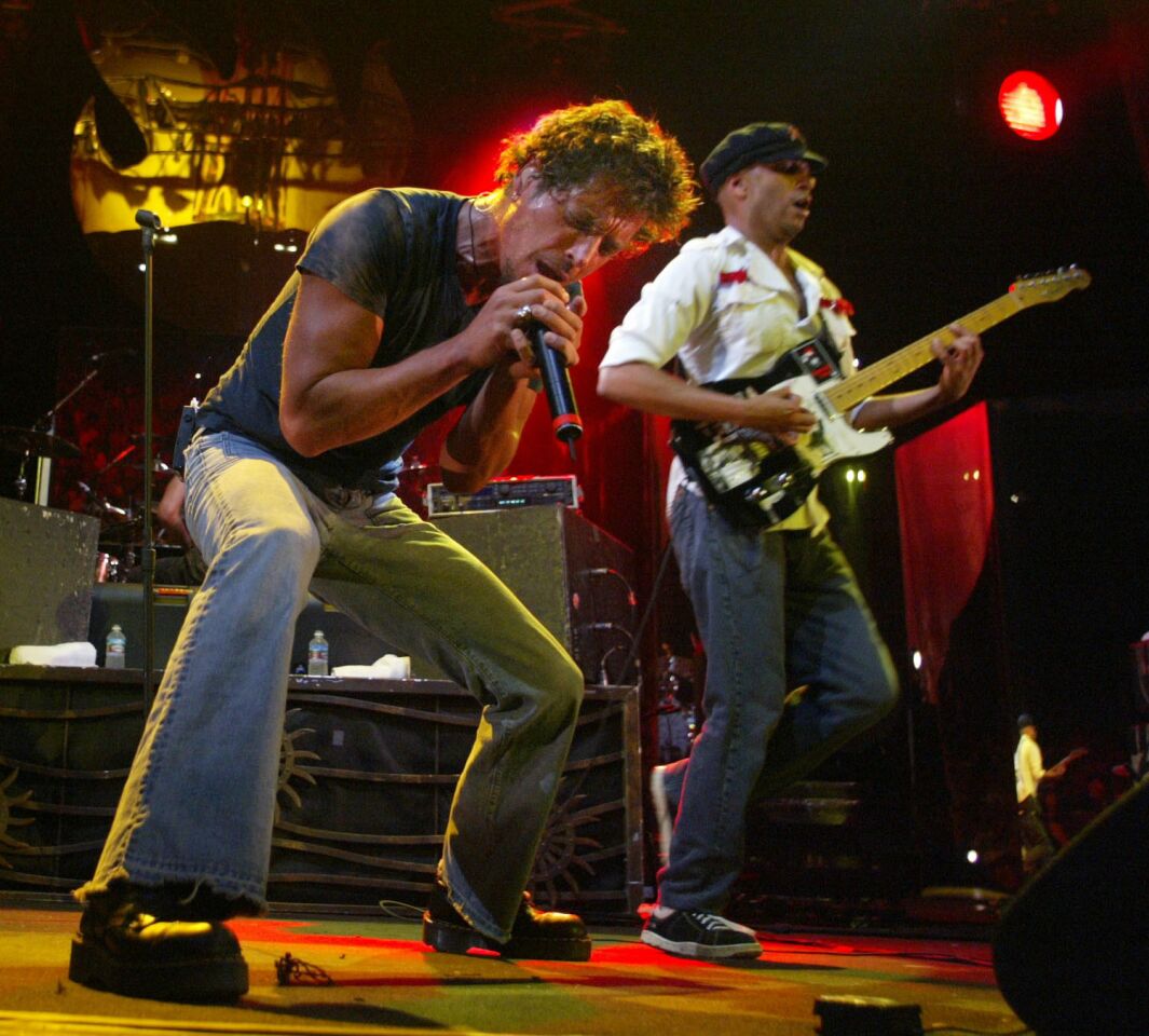 Audioslave's Chris Cornell sings as guitarist Tom Morello plays at the Lollapalooza concert in Irvine on Aug 16, 2003.