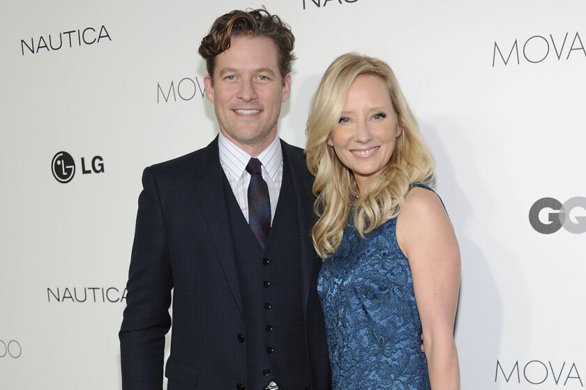 FILE - Actors James Tupper, left, and Anne Heche attend the The 2012 Gentlemen's Ball hosted in New York on Oct. 24, 2012. Heche, who first came to prominence on the NBC soap opera “Another World” in the late 1980s before becoming one of the hottest stars in Hollywood in the late 1990s, died Sunday, Aug. 14, 2022, nine days after she was injured in a fiery car crash. She was 53. (Photo by Evan Agostini/Invision/AP, File)