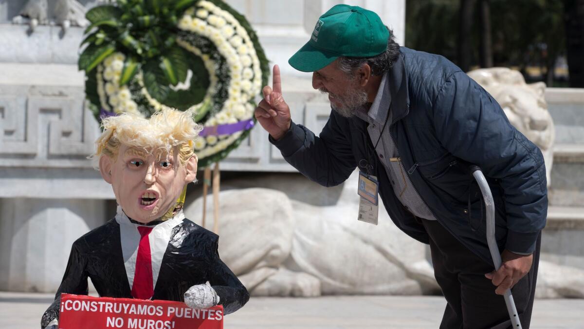 A man shouts at a pinata of Donald Trump in Mexico City on Oct. 12.