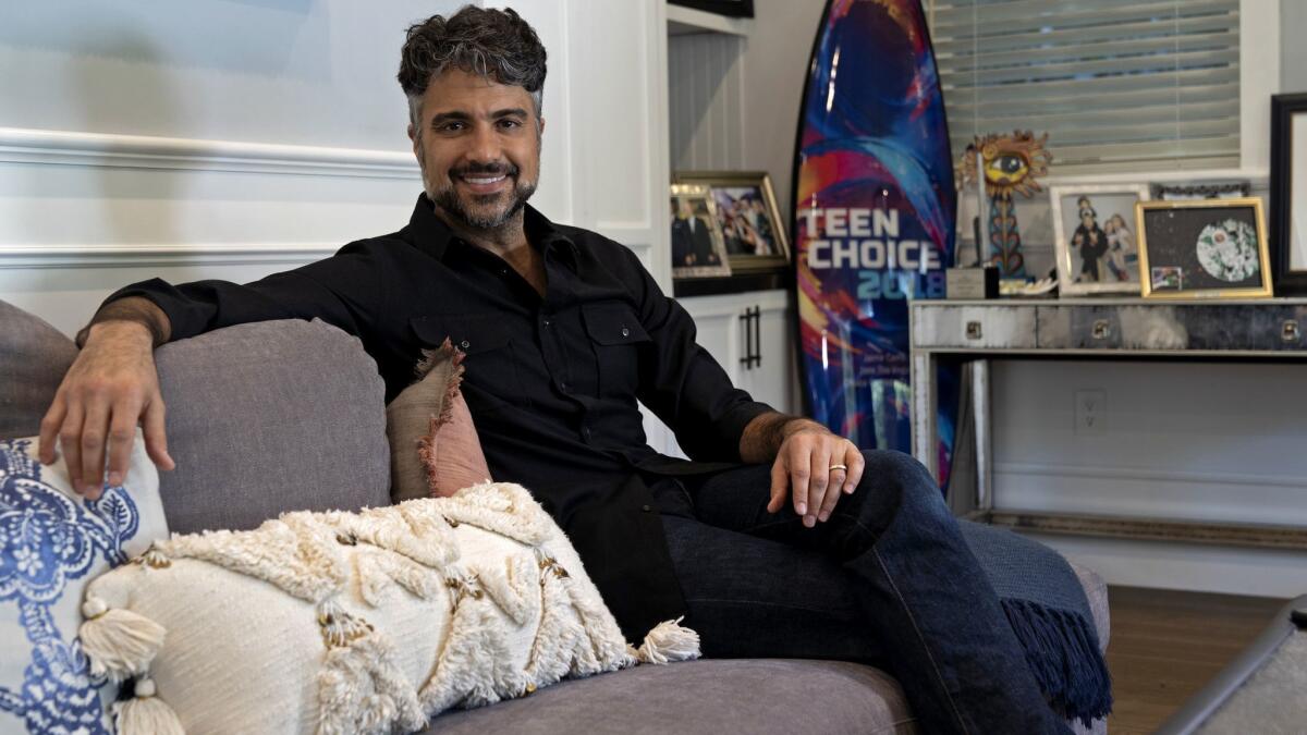 STUDIO CITY, CALIF. - DEC. 11, 2018 "Jane the Virgin" actor Jaime Camil enjoys spending time with the kids in his multi-purpose living room filled with comfortable furniture and fond memories. (Wesley Du / Los Angeles Times)