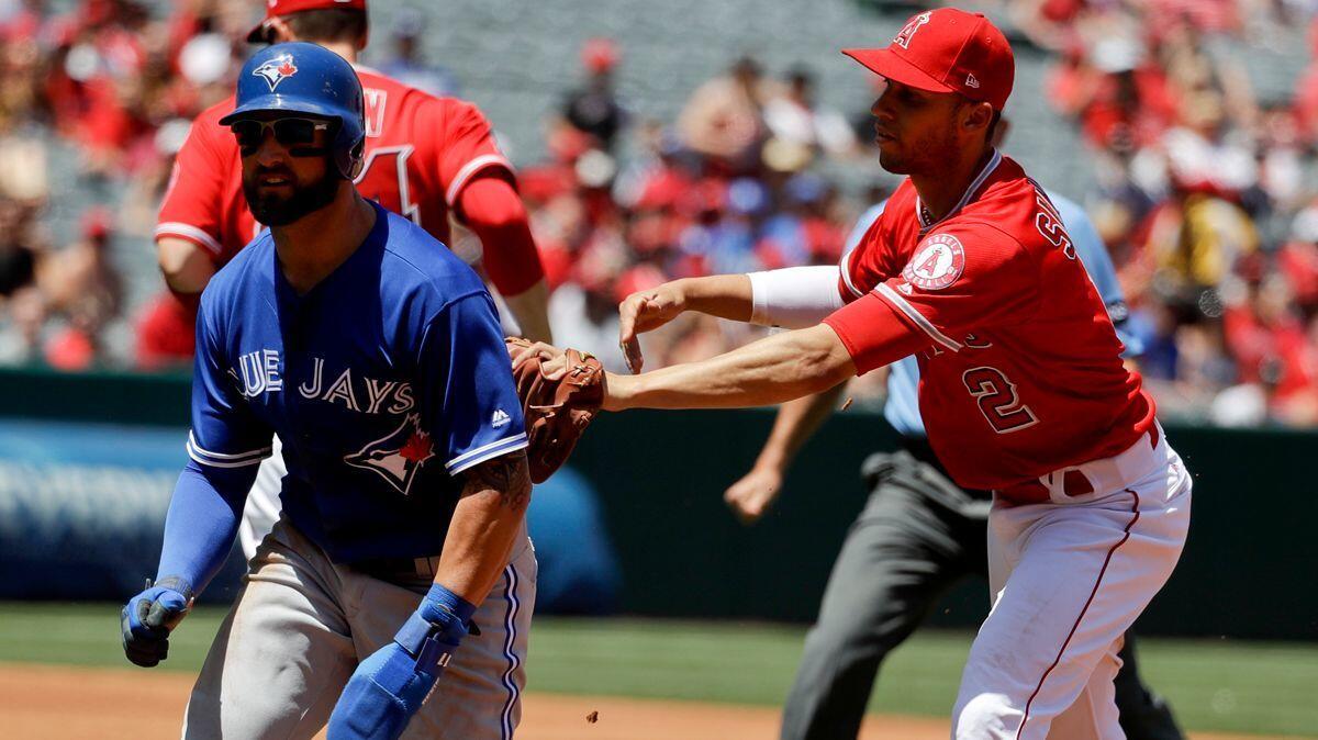 Angels shortstop Andrelton Simmons, right, tags Toronto Blue Jays' Kevin Pillar in a rundown during the third inning Sunday.