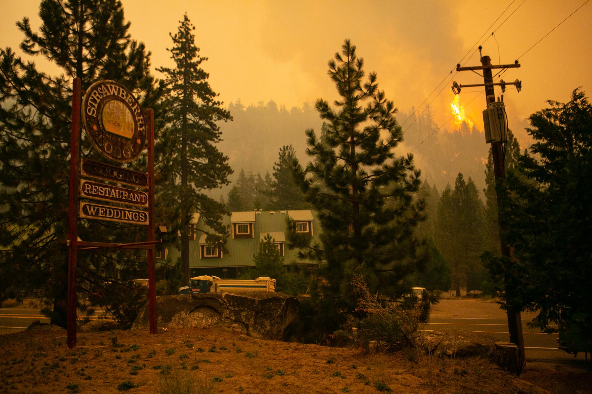 A spot fire burns on the ridge behind the Strawberry Lodge