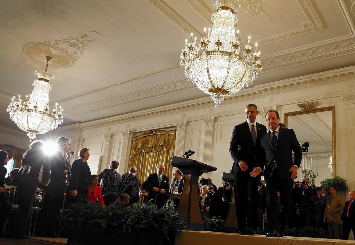 President Obama and French President Francois Hollande leave a news conference at the White House. The only hint of tension between the close allies concerned a visit by French business executives to Iran last week.