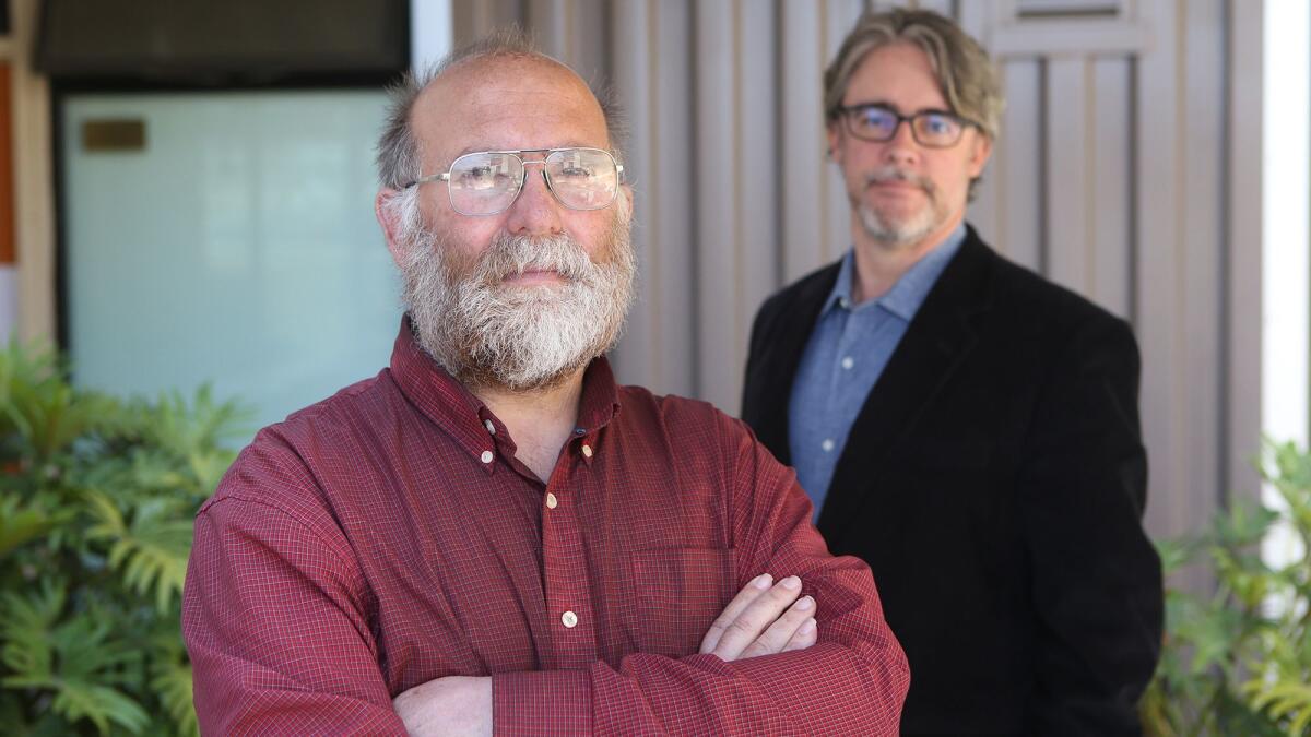 William Odell, left, and Milo Peinemann at the American Family Housing office in Midway City. Odell is a former homeless man who was brought onto the nonprofit's board of directors.