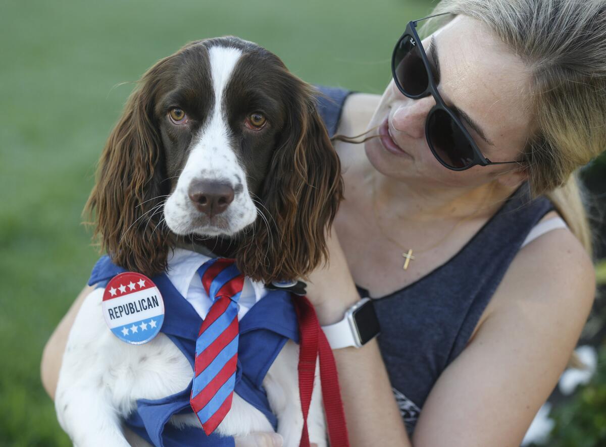 Katie Kristoff, 30, holds her dog Emma at a Newport Beach polling place.