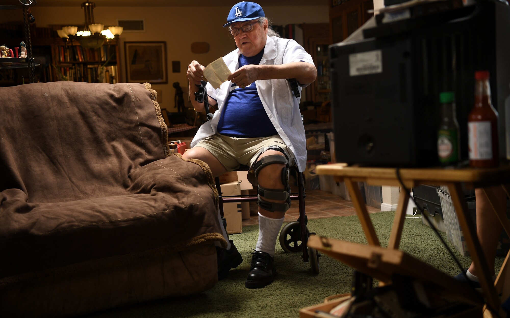 Conrad Munatones goes through some old photos at his home in San Dimas.