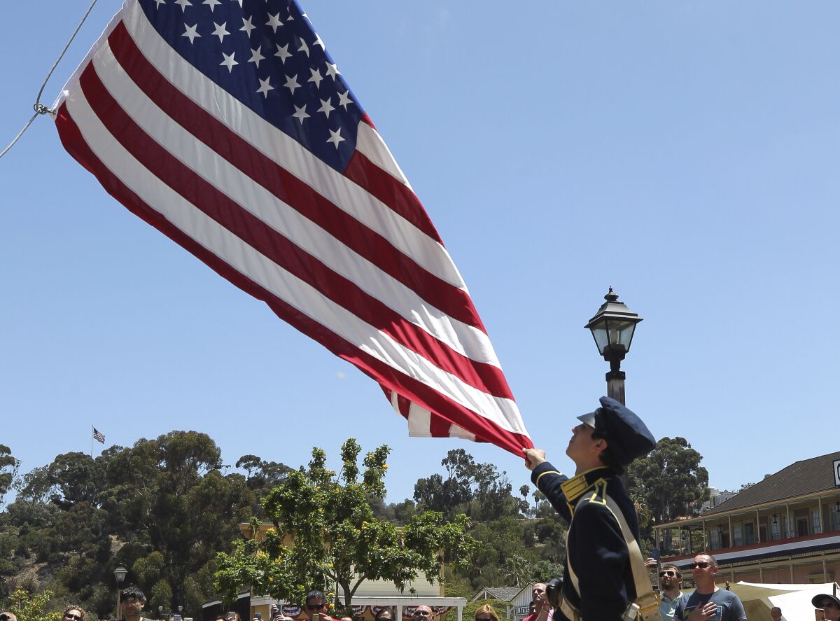 The flag is raised during the Old Town 1800's July Fourth celebration at Old Town San Diego State Historic Park in 2019.