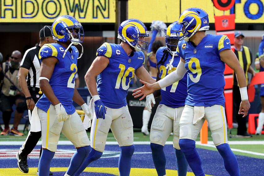 Rams wide receiver Cooper Kupp is congratulated by teammates after making a touchdown catch against Detroit on Oct. 24, 2021.