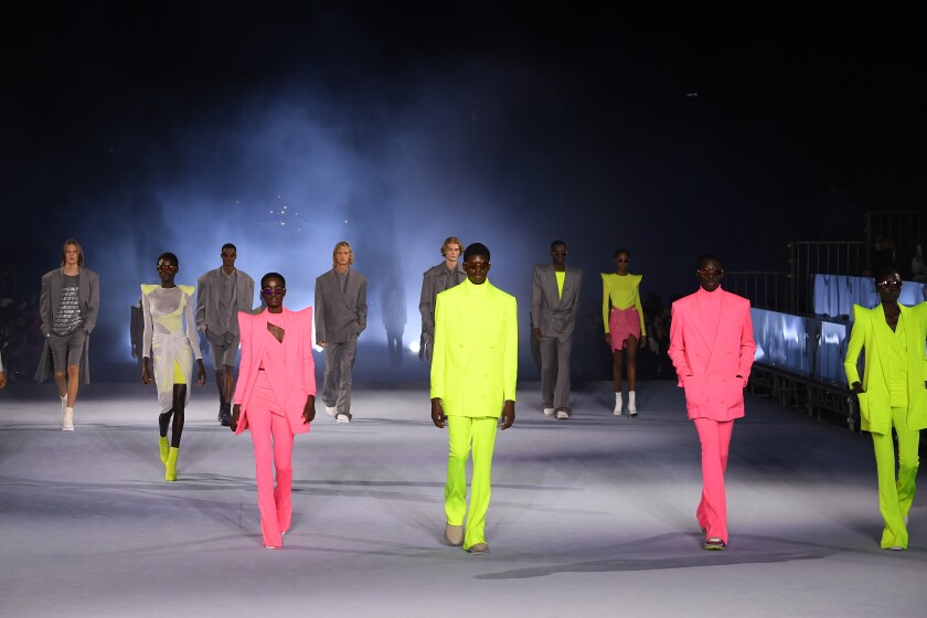 Models with pops of neon colors walking the runway at a Balmain fashion show