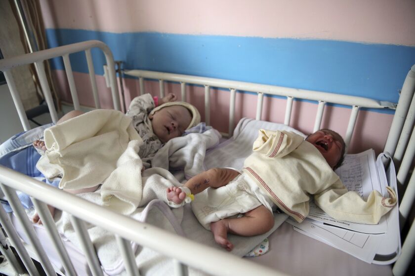 Newborn babies lie in their beds at the Ataturk Children's Hospital a day after they were rescued from a deadly attack on another maternity hospital, in Kabul, Afghanistan, Wednesday, May 13, 2020. Militants stormed the Barchi National Maternity Hospital in the western part of Kabul on Tuesday, setting off an hours-long shootout with the police and killing tens of people, including two newborn babies, their mothers and an unspecified number of nurses, Afghan officials said. (AP Photo/Rahmat Gul)