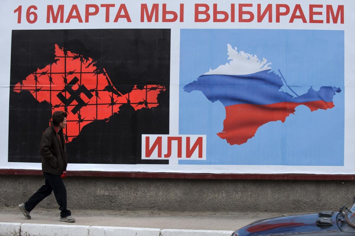 A billboard in the Crimean port of Sevastopol reminds voters in the breakaway Ukrainian area: "On March 16 we choose," with Crimea depicted as subject to rule by Nazis or Russia.
