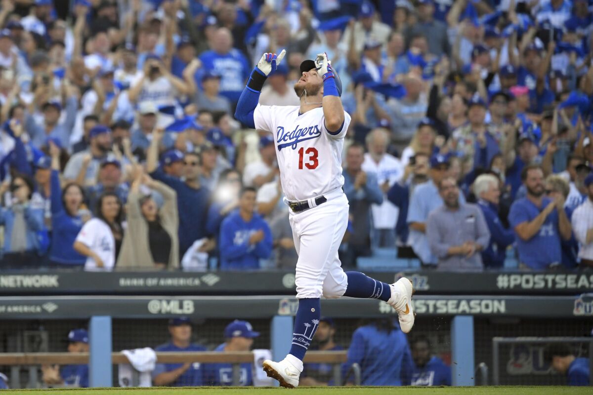 FILE- In this Oct. 9, 2019, file photo, Los Angeles Dodgers' Max Muncy celebrates his two-run home run against the Washington Nationals during the first inning in Game 5 of a baseball National League Division Series in Los Angeles. Muncy and the Dodgers agreed to a $26 million, three-year contract Thursday, Feb. 6, 2020, and avoided salary arbitration. (AP Photo/Mark J. Terrill, File)