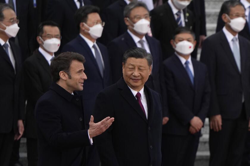 French President Emmanuel Macron, bottom left, chats with Chinese President Xi Jinping during a welcome ceremony held outside the Great Hall of the People in Beijing, Thursday, April 6, 2023. (AP Photo/Ng Han Guan, Pool)