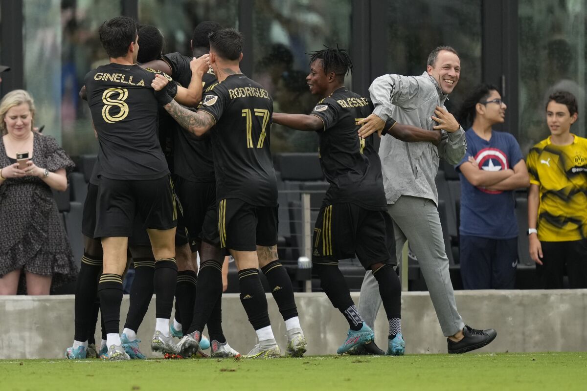 LAFC coach Steve Cherundolo congratulates players as they celebrate after scoring