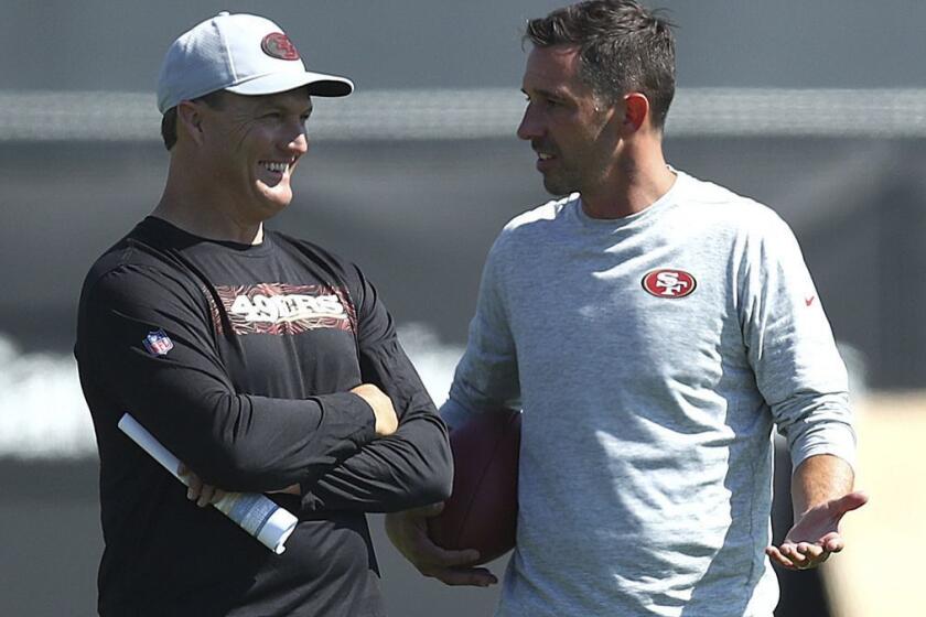 San Francisco 49ers coach Kyle Shanahan, right, speaks with general manager John Lynch during NFL football practice at the team's headquarters Thursday, July 26, 2018, in Santa Clara, Calif. (AP Photo/Ben Margot)