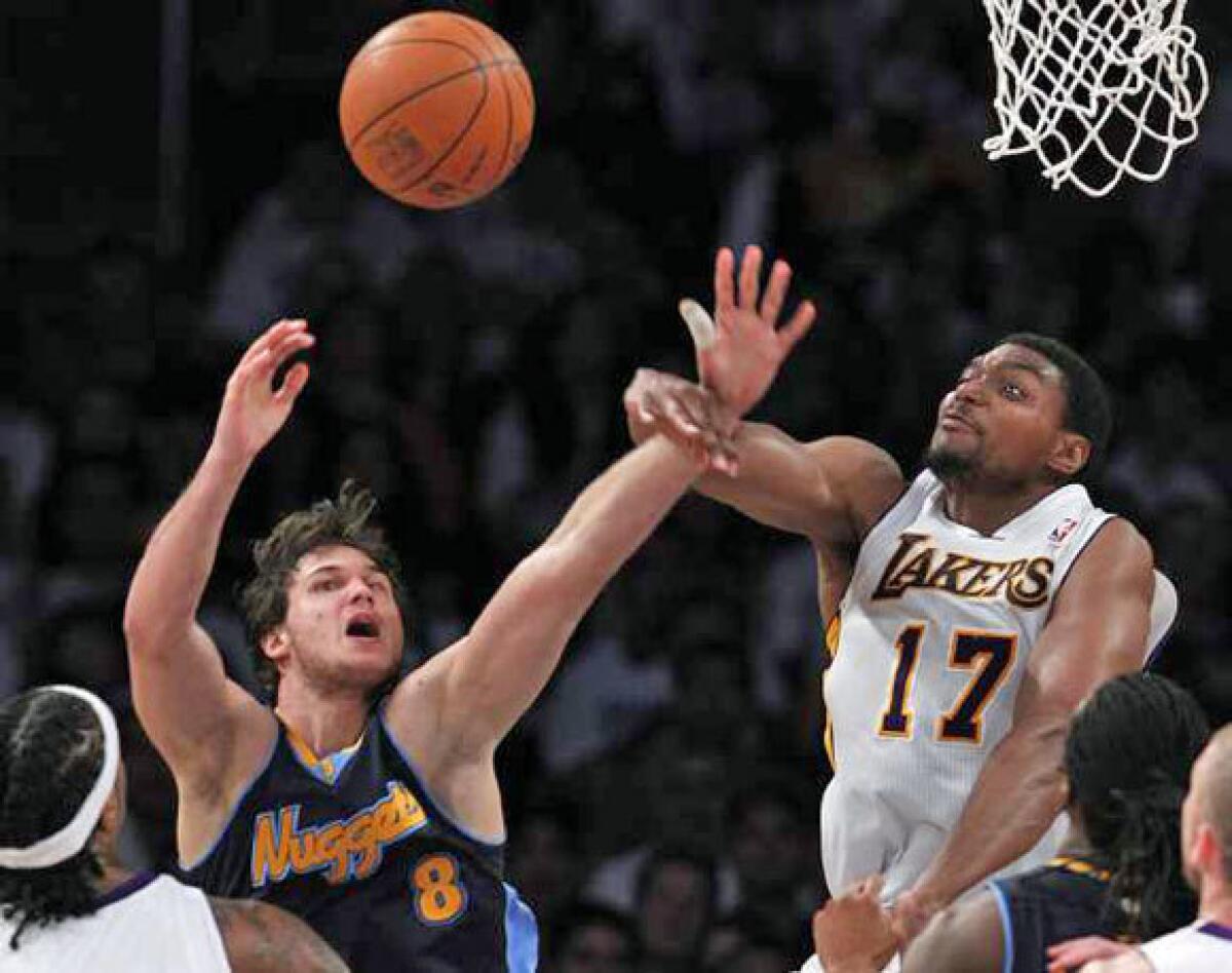 Andrew Bynum blocks the shot of Nuggets forward Danilo Gallinari in the second half of Game 1.