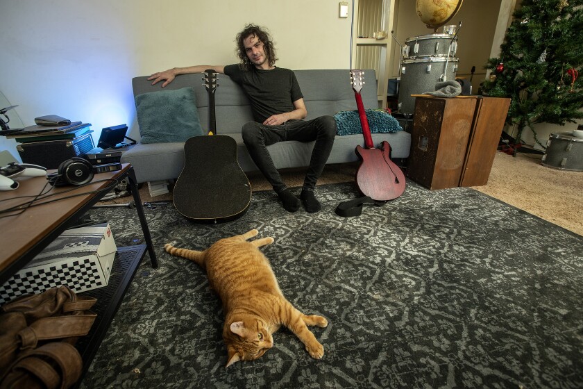 Rob Leonard with his cat inside his apartment in Santa Monica.