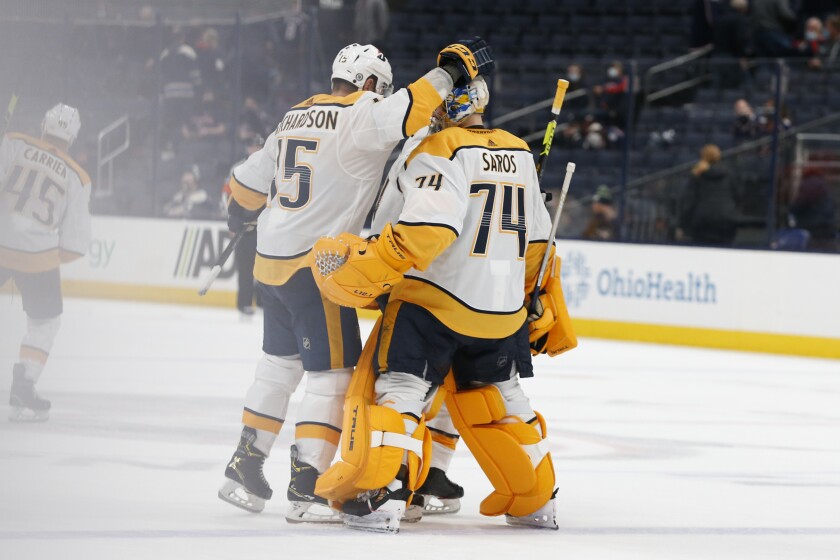 Nashville Predators' Brad Richardson, left, congratulates Juuse Saros after their win over the Columbus Blue Jackets' in an NHL hockey game Monday, May 3, 2021, in Columbus, Ohio. (AP Photo/Jay LaPrete)