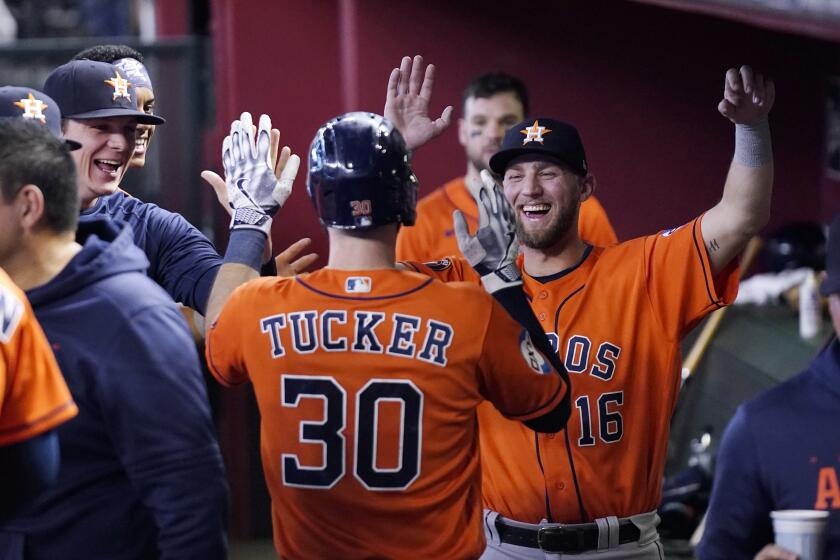 Houston Astros' Kyle Tucker (30) celebrates after his run scored against the Arizona Diamondbacks with teammates, including Astros' Grae Kessinger (16), during the fifth inning of a baseball game Sunday, Oct. 1, 2023, in Phoenix. Tucker hit a triple on the play and scored on a throwing error by Diamondbacks right fielder Jake McCarthy. (AP Photo/Ross D. Franklin)