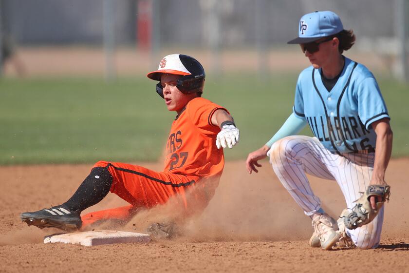 Trevor Goldenetz (27) of Huntington Beach slides safely into second with a stolen base during the second round of the Div-1 baseball playoffs against Villa Park on Tuesday.