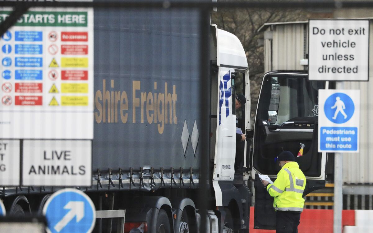 A heavy goods vehicles is checked at the Department of Agriculture, Environment and Rural Affairs checking site at Belfast Docks, Thursday Feb. 3, 2022. Officials in Northern Ireland sought legal advice Thursday, after a government minister ordered them to stop inspecting cargoes arriving from other parts of the U.K., in violation of the Brexit agreement between Britain and the European Union. Shipments continued to move through the port of Belfast on Thursday morning, though it was unclear whether they were undergoing the required checks, Irish broadcaster RTE reported. (Peter Morrison/PA via AP)
