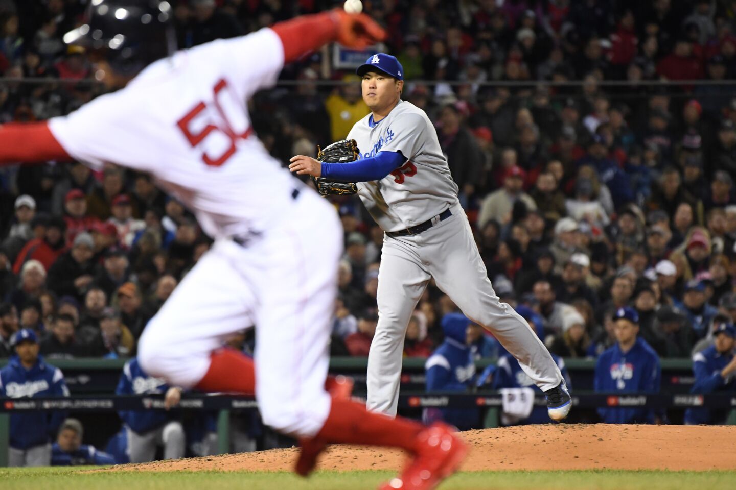 Dodgers pitcher Hyun-Jin Ryu throws to first as Red Sox's Mookiie Betts dives back.