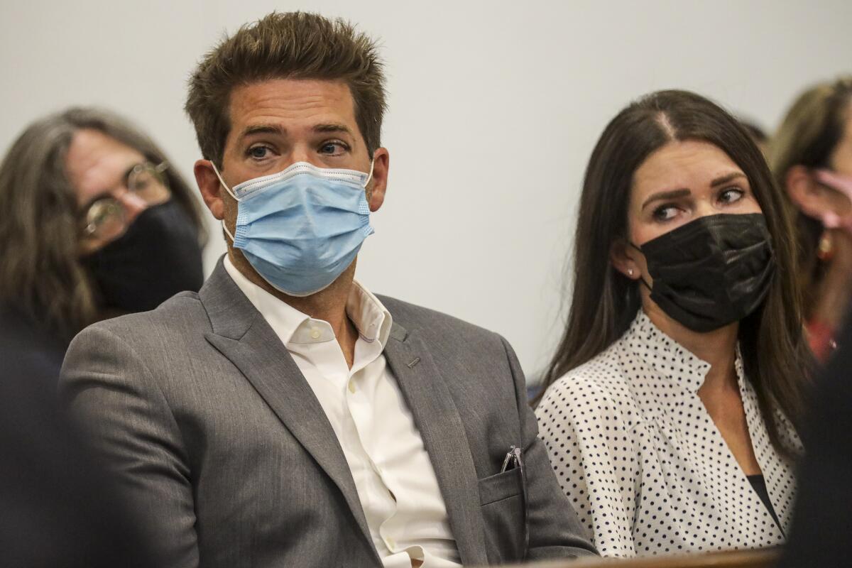 Accused doctor and his girlfriend masked up in court 