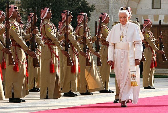Pope Benedict XVI reviews the honor guard as he arrives at the Royal Palace in Amman. He expressed deep respect for Islam on Friday and said he hopes the Catholic Church can play a role in Mideast peace as he began his first trip to the region, where he hopes to improve frayed ties with Muslims. The pope was met at the airport by Jordan's King Abdullah and praised the moderate Arab country as a leader in efforts to promote peace in the region and dialogue between Christians and Muslims.