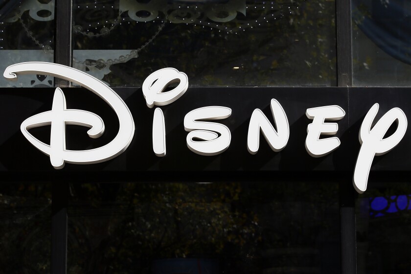 FILE - This Sept. 20, 2017, file photo shows a sign at the Disney store on the Champs Elysees Avenue in Paris, France. The Supreme Court’s decision to end the nation’s constitutional protections for abortion has catapulted businesses of all types into the most divisive corner of politics. A rash of iconic names including The Walt Disney Company, Facebook parent Meta, and Goldman Sachs announced they would pay for travel expenses for those who want the procedure but can't get it in the states they live in. (AP Photo/Francois Mori, File)