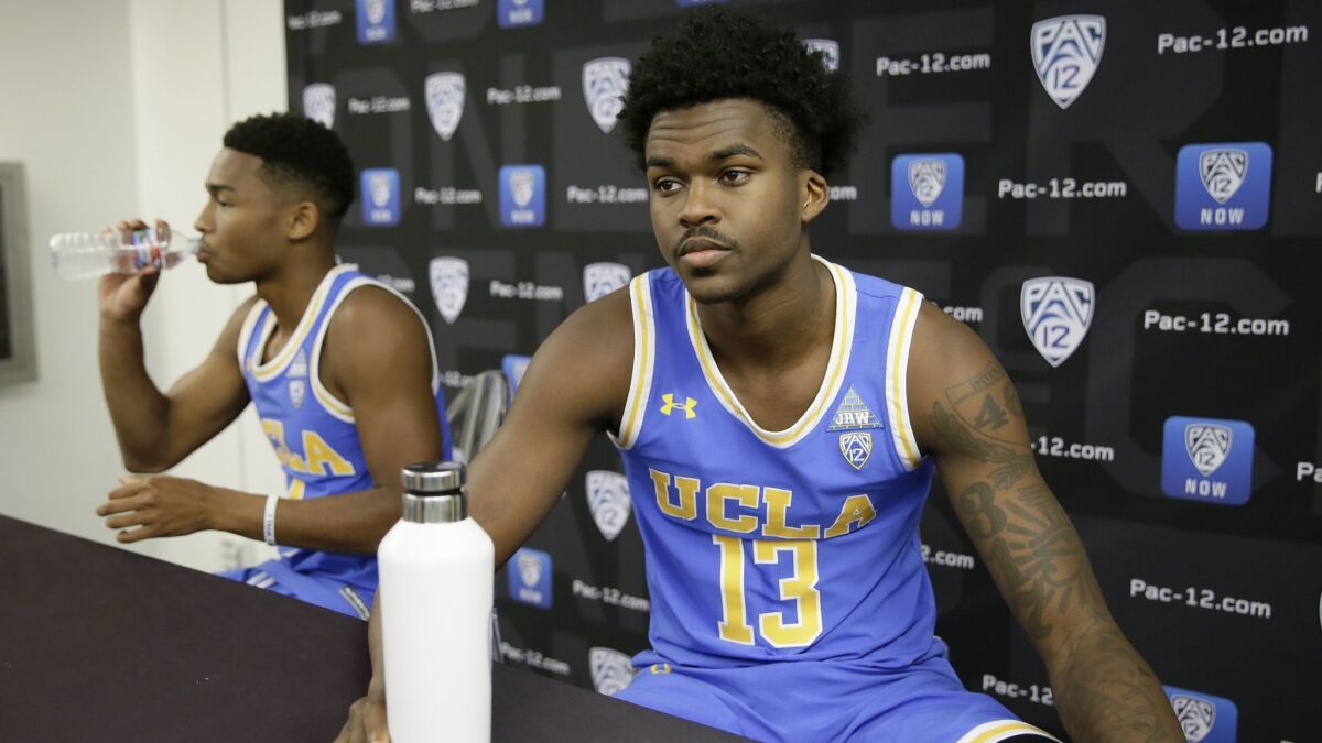 UCLA's Kris Wilkes, right, and Jaylen Hands, left, listen to questions during Pac-12 media day.