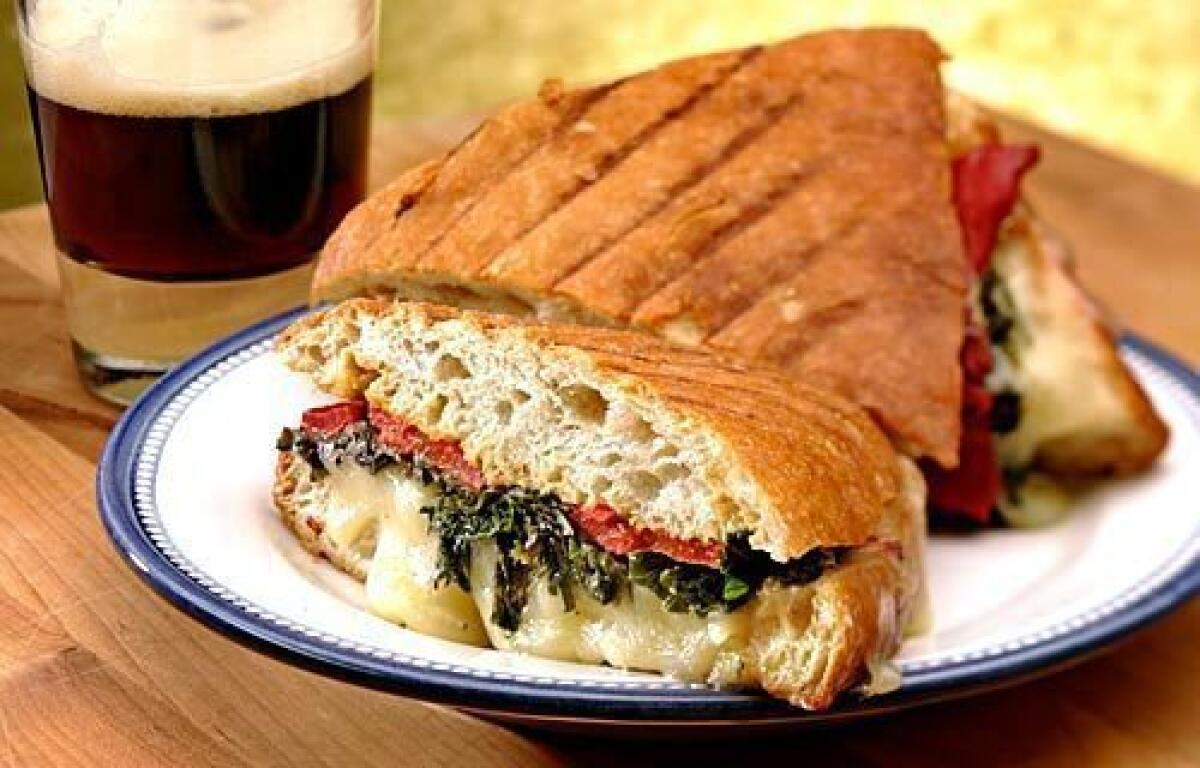 Green panini with roasted peppers and Gruyere cheese.