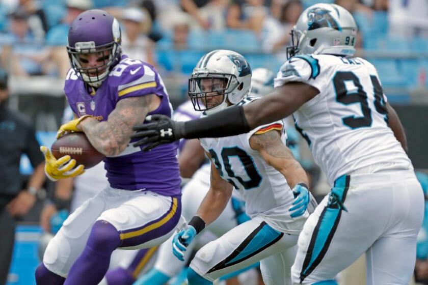 Vikings tight end Kyle Rudolph shields the ball from Panthers defenders during a game on Sept. 25.