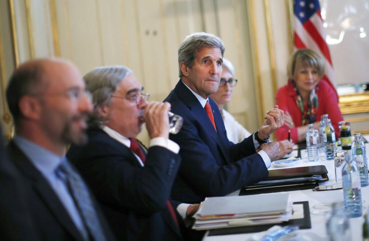 Secretary of State John F. Kerry, center, during nuclear talks with the Iranian foreign minister in Vienna on Friday.