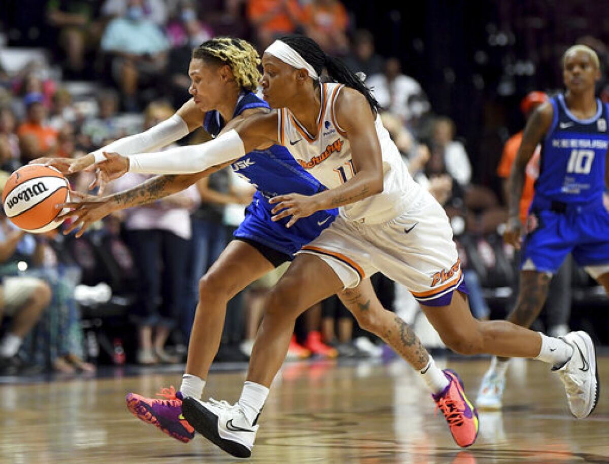 Connecticut Sun guard Natisha Hiedeman, left, and Phoenix Mercury guard Shay Peddy (11) reach for the ball during a WNBA basketball game Thursday, Aug. 4, 2022, in Uncasville, Conn. (Sarah Gordon/The Day via AP)