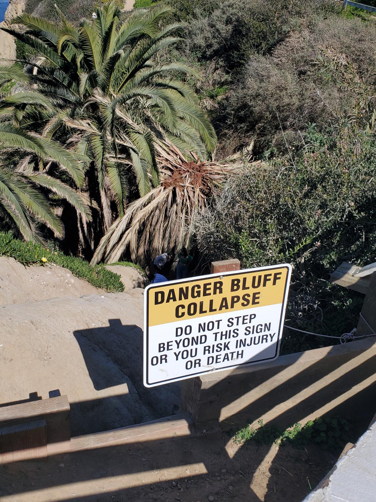 A sign directs people away from the steep path that leads to the "secret swing."