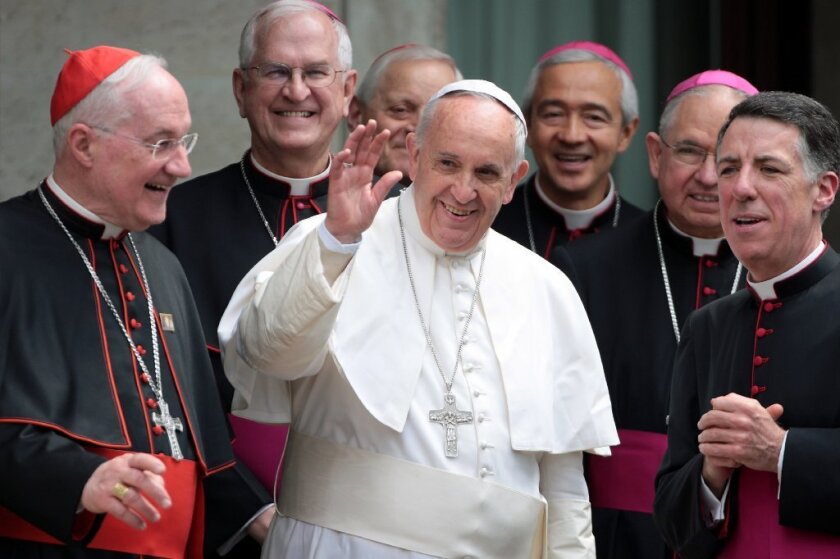 L.A. Archbishop Jose H. Gomez, second from right, helps usher Pope Francis out as he leaves the Pontifical North American College on Saturday after a conference sponsored by the Los Angeles archdiocese on the canonization of Father Junipero Serra.