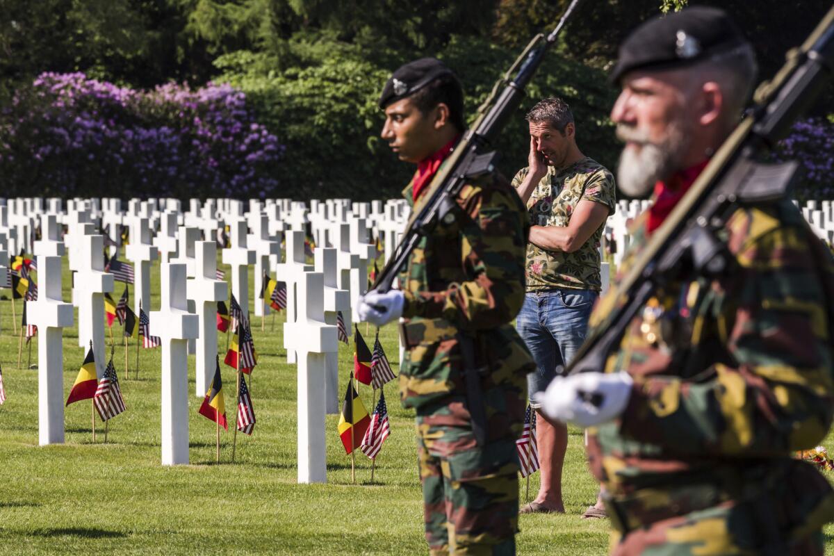 Honor guards march at a Memorial Day ceremony at the Henri-Chapelle American Cemetery and Memorial in Belgium. It includes 7,992 U.S. military dead.