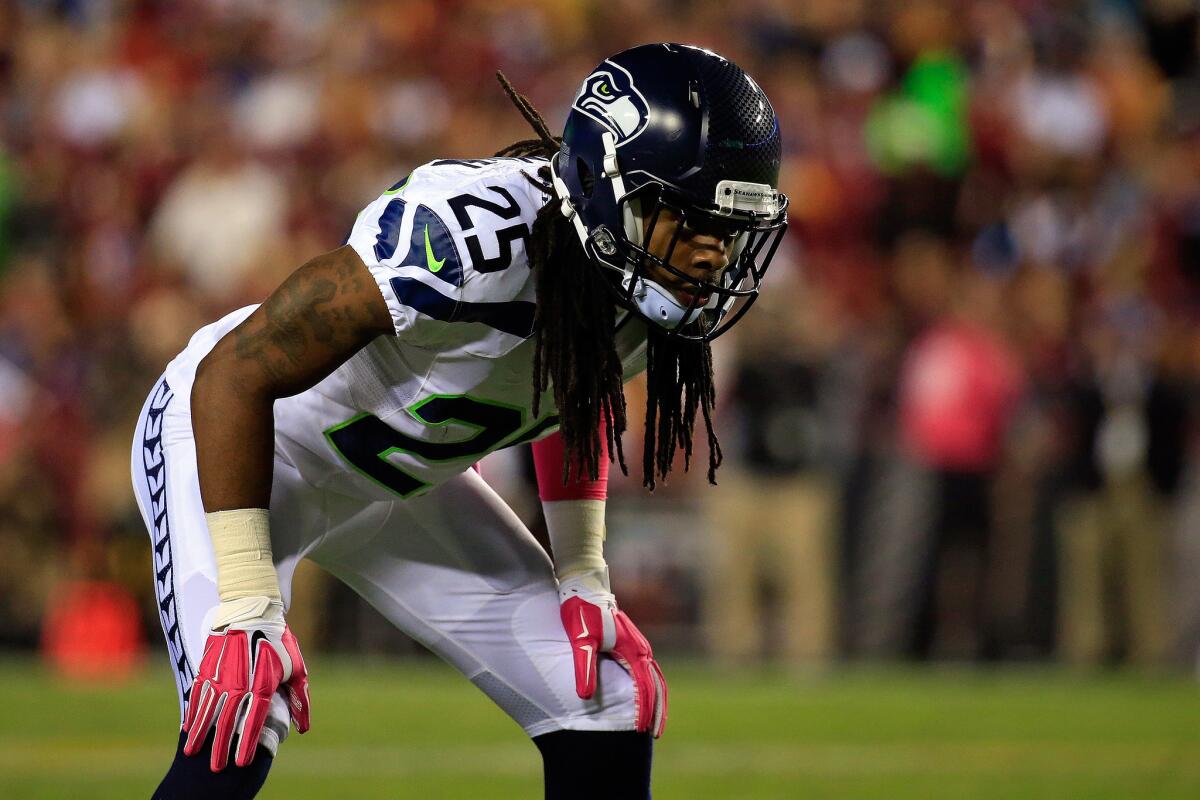 Seattle cornerback Richard Sherman and his dreadlocks await the snap against Washington on Monday night.